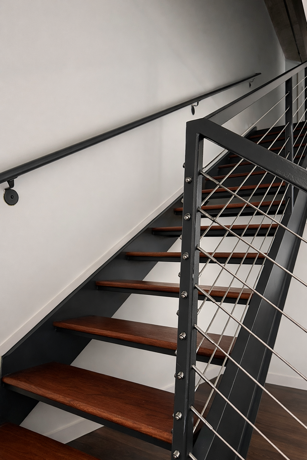 Everything in this shot feels like movement, even though it’s completely still. Diagonals create energy in the frame and guide the viewer’s eye upward, making the staircase feel dynamic and intentional.