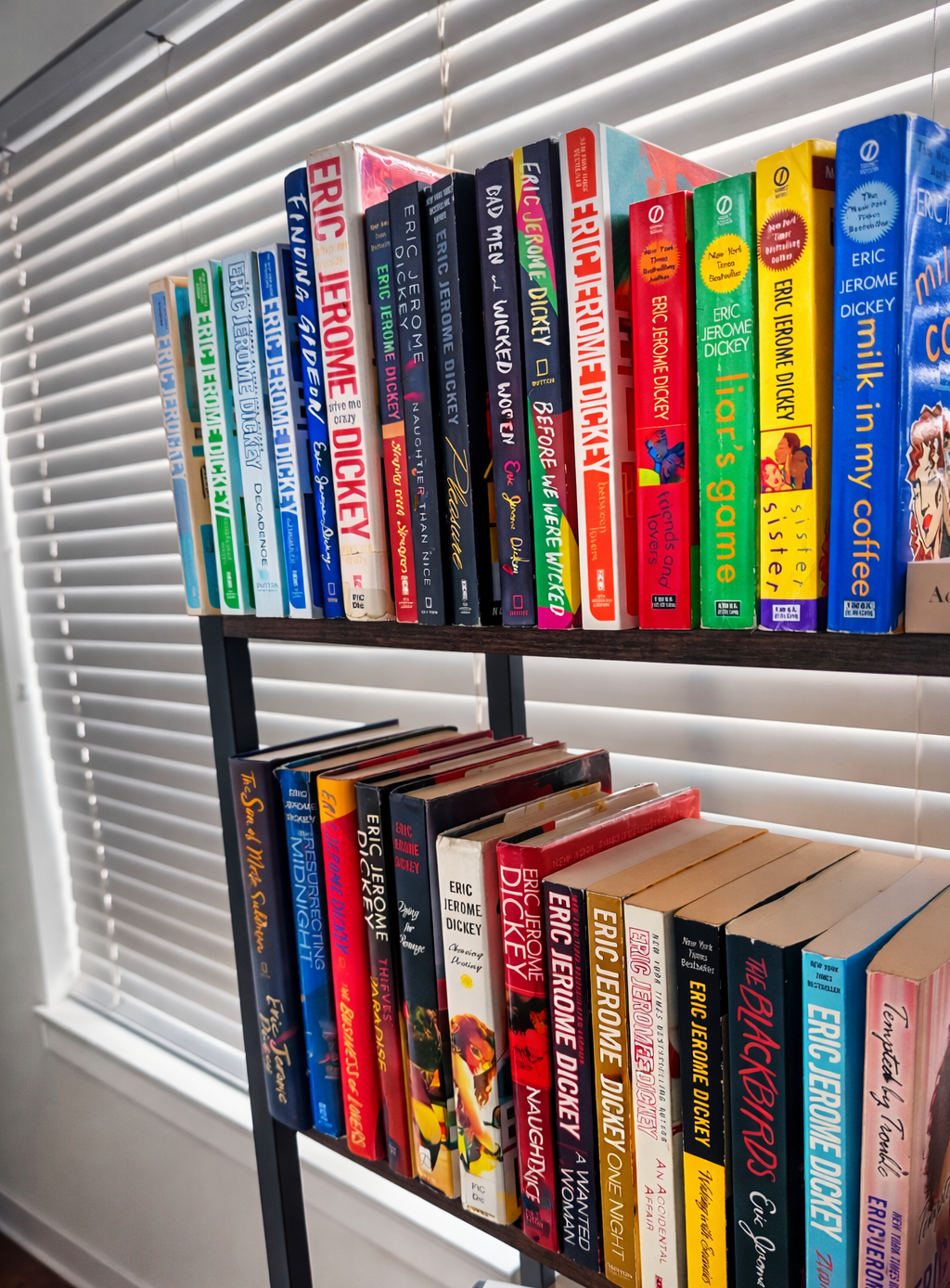 A shelf full of stories that stand out before you even read a page. Contrast makes the bold book colors pop against the neutral background, guiding the viewer’s eye across each title.